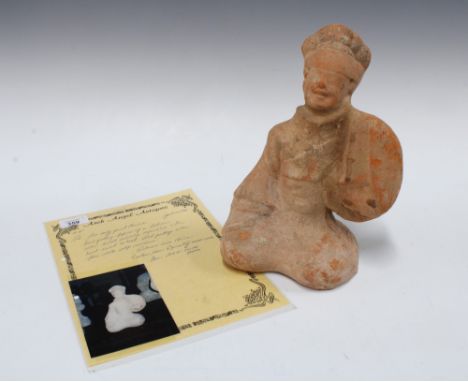 Chinese red pottery kneeling figure, 27cm, with a laminated handwritten receipt from Arch Angel Antiques attributing the figu