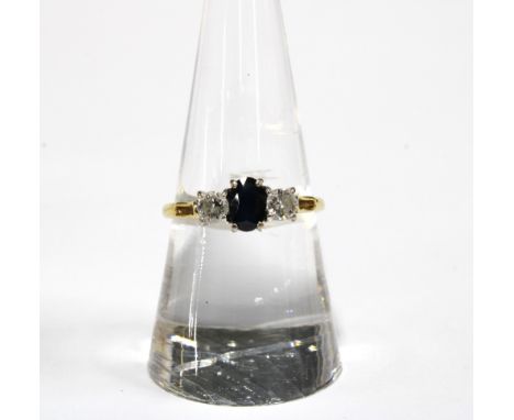 18ct gold three stone diamond and sapphire ring, stamed 750