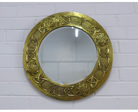 After Margaret Gilmour,  a circular brass wall mirror, the frame with Glasgow School motifs and celtic knotwork, 48cm.