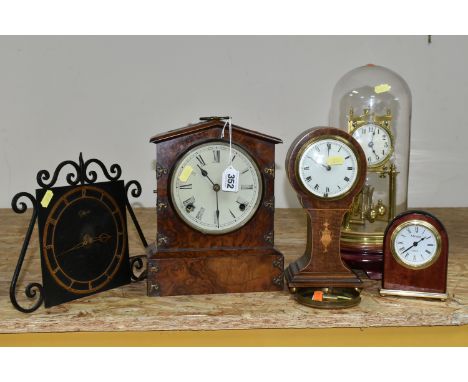 A GROUP OF FIVE CLOCKS, comprising a German anniversary clock, marked 154124 with key (not on original wooden stand), height 