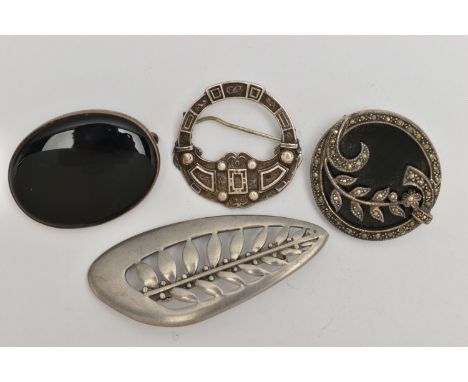 FOUR SILVER AND WHITE METAL BROOCHES, the first an oval onyx brooch with silver fittings, hallmarked London, a silver Scottis