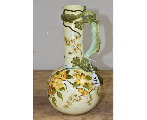 A LATE NINETEENTH CENTURY DOULTON LAMBETH FAIENCE EWER, with green handle in the form of a dragon, the bulbous body painted w