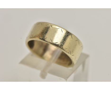 A YELLOW METAL BAND RING, a wide band ring with etched detail, approximate width 7mm, stamped 9ct, ring size K 1/2 leading ed