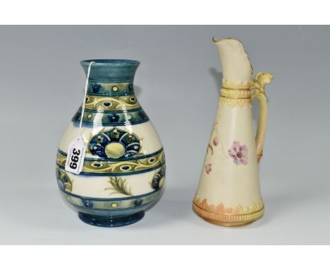 A 1930s MOORCROFT POTTERY VASE AND A ROYAL WORCESTER BLUSH IVORY JUG, the Moorcroft baluster vase in a simplified banded vers