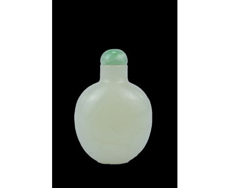 A Chinese 18th/19th century mutton fat Jade Snuff Bottle carved in relief with orchids with jade stopper. 6cm tall. Purchased