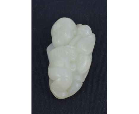 A Chinese White Jade carving of a Child. 5.5cm