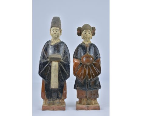 A pair of Ming dynasty style pottery figures of man and woman. (2)