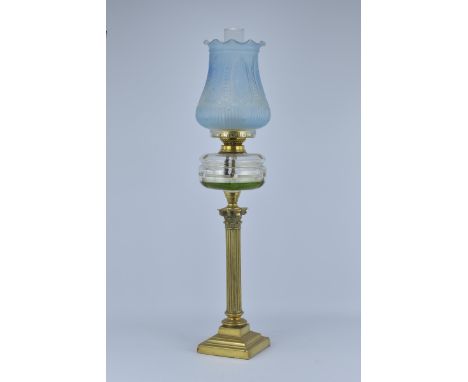 An antique English Victorian Brass Oil lamp with Glass Oil Reservoir and Shade.