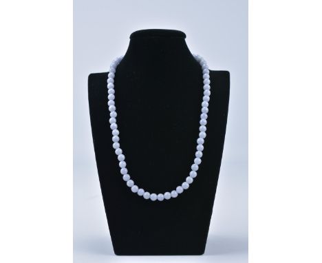 A Single Row Of 64 Ungraduated natural lavender colour jadeite jade beads, polished with a Pearl Mounted Clasp. Varying in di