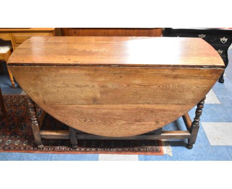 A Mid/Late 20th Century Oval Topped Gate Leg Drop Leaf Wake Table in Oak, 143cm wide 