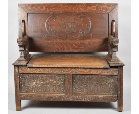 A Carved Oak Monks Bench with Panelled Front and Lift up Seat, 104cm wide 