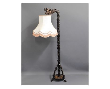 An early 20thC. carved Chinese hardwood dragon lamp, 71in tall