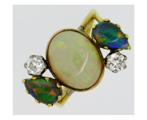 An 18ct gold ring set with centre opal of 12.1mm x 10mm, two diamonds, totalling 0.5ct &amp; two pear shaped black opals, 6.7