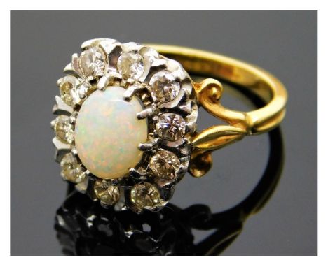 An 18ct gold ring set with opal &amp; 0.7ct diamonds, opal 8.35mm x 6.25mm, 6.4g, size N