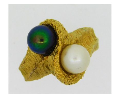 An 18ct gold crossover ring set with a Tahitian &amp; cultured pearl, both 7mm in diameter, 8.81g, size O