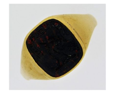 An antique yellow metal seal ring, electronically tests as 18ct gold, set with carved intaglio blood stone with motto "Wales 