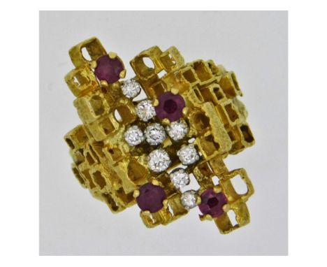 An early 1970's 18ct gold avant-garde style ring set with four rubies of approx. 3.35mm diameter &amp; approx. 0.28ct diamond