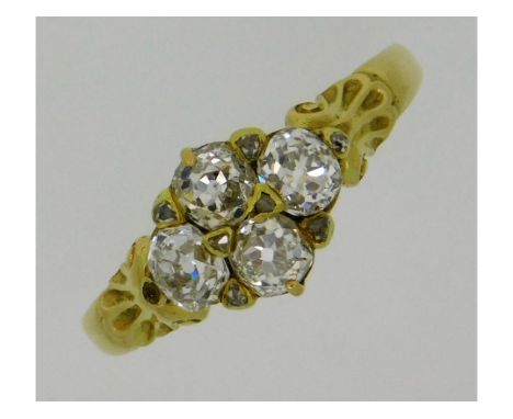 A Victorian yellow metal ring, electronically tests as 18ct gold, set with four good colour &amp; clarity old cut diamonds of