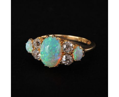 Set with 3 opals and 4 diamonds largest is 6 x 8 mm. ring size 17.