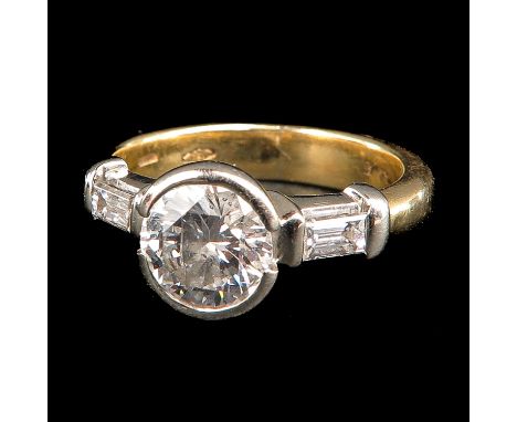 Set with 2 baguette diamonds and 1 brilliant cut diamond 7 mm. in diameter approximately 1.25 carat ring size 17.