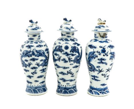 Decorated with dragons and clouds, Kangxi mark, tallest vase is 28 cm., with restorations.