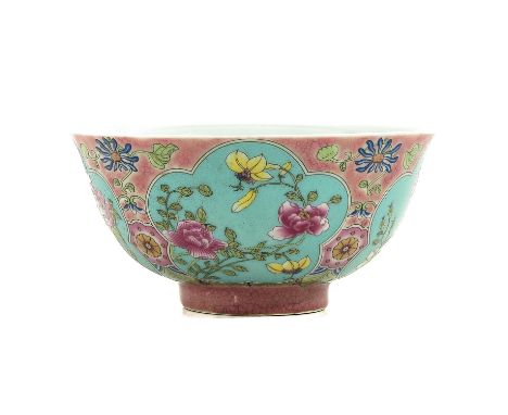 Pink ground decorated with 4 floral panels, Kangxi mark, 15 cm. in diameter, chip on rim.
