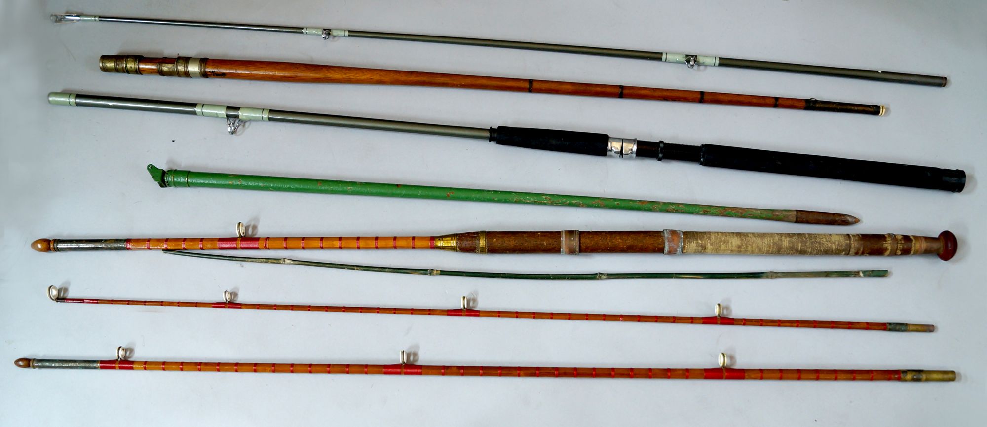 A cane fishing rod, 20th century, with cork grip to handle and brass