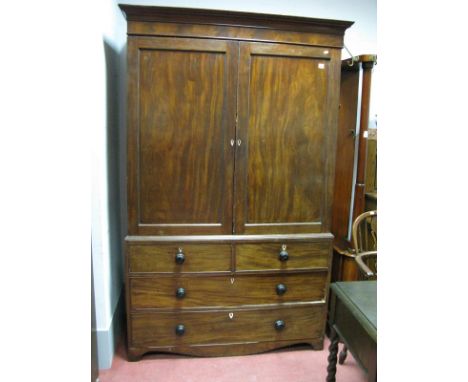 Early XIX Century Mahogany Linen Press, with a stepped cornice, twin panelled doors, with internal slides, two short and two 