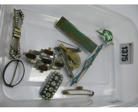 An Enamel Bar Brooch, of Art Deco style, with floral detail, (damages), another similar of blue colour, an enamel fish pendan