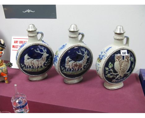 Three Goebel Saltglazed Stoneware Limited Edition Moon Faced Flagons, moulded with deer and owls.