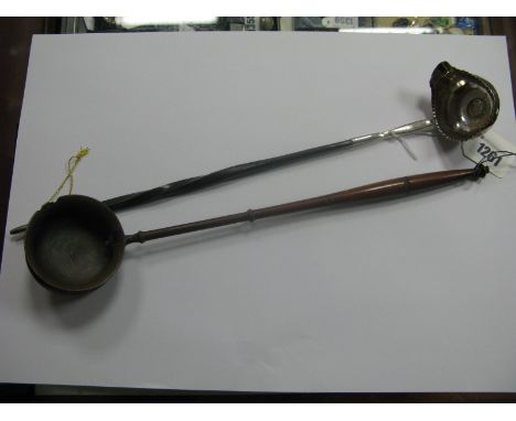 A Georgian Toddy Ladle, the bowl with side lip and inset coin to base (1762), twisted handle, overall length 39cm; a turned w