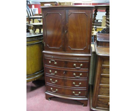 A Mahogany Cocktail Cabinet, with panelled doors, brushing slide, single drawer, hinged door, on bracket feet.