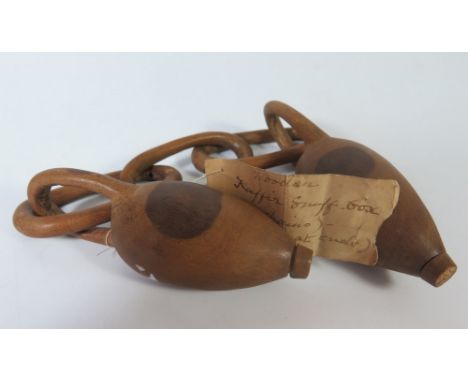 A Nineteenth Century Wooden Carving with old label _ 'Wooden Kaffir Snuff-box (with chains) - (opens at ends)