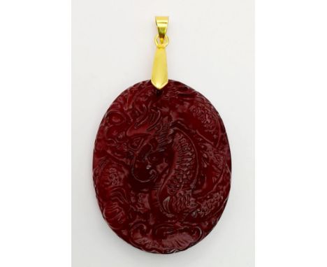 A Red Jade Pendant with Carved Decoration 