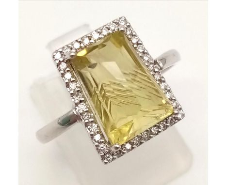 A 9K White Gold Citrine Diamond Ring. Emerald cut citrine with a diamond surround. 0.35ct. Size R.4g. 