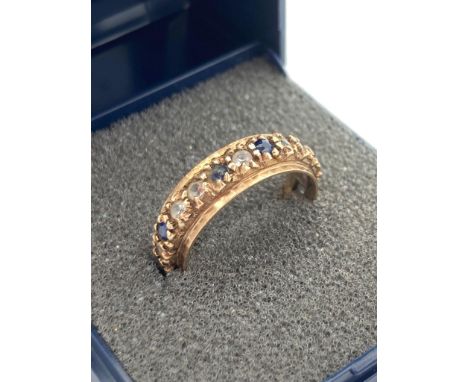 9 carat GOLD and SAPPHIRE ETERNITY RING having sapphires and clear white stones set to band. 3.25 grams. Size M - M 1/2. 