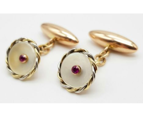 A PAIR OF VICTORIAN 10K ROSE GOLD CUFFLINKS WITH MOTHER OF PEARL AND RUBY CENTRE STONE.   6.7gms 