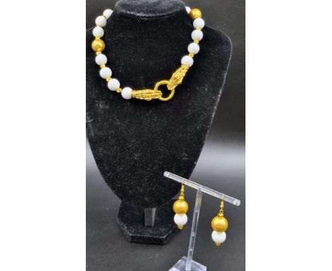 An unusual, Chinese, white jade necklace and earrings set with an 18 K yellow gold plated twin dragon clasp and accent beads.