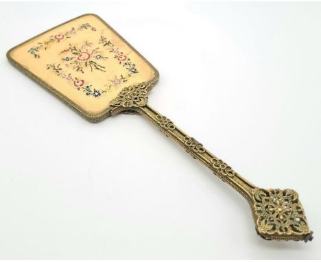 A Beautiful Vintage (1930s) Hand Mirror. Petit point rose decoration on reverse of mirror. Filigree brass decoration on handl