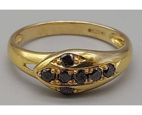 A 9K Vintage Yellow Gold Ring with seven Sapphires in a Serpentine shape. Size K. Total weight: 1.59g 