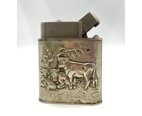 A large, sterling silver, table lighter, with pastoral scenes. Dimensions: 9.5 x 8 x 3 cm, weight: 334 g. 