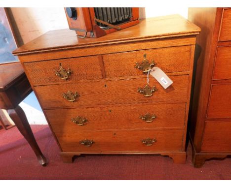 A Georgian oak chest of two short over three graduated drawers with brass handles, raised on bracket supports. H-91cm, W-92cm