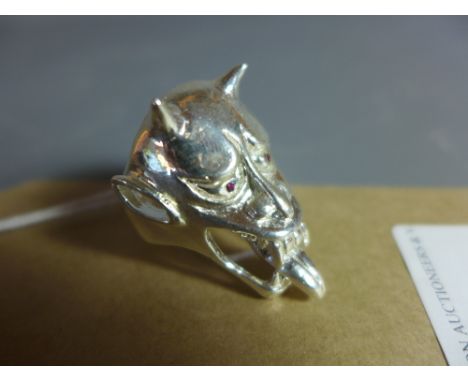 A silver ring in the form of a Japanese mythical creature with ruby eyes.
