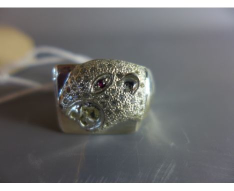 A silver ring in the form of a panther head set with ruby eye. 