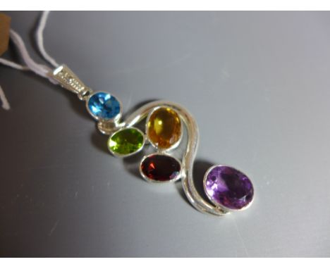 A silver pendant set with amethyst, blue topaz, ruby, peridot and amber quartz. 