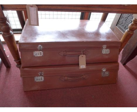 A graduated pair of brown leather automobile suitcases having slanted fronts. H-33cm, W-89cm, D-64cm stacked together. 