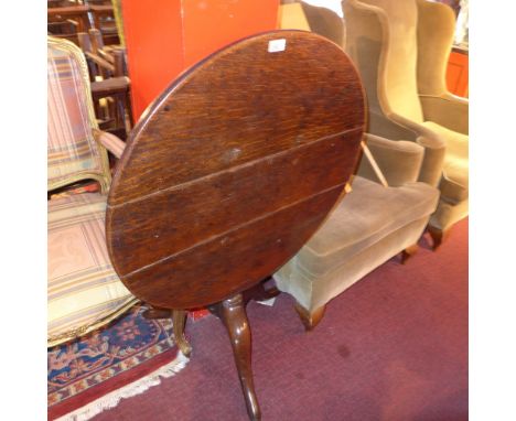 A 19th Century oak circular tilt top table, raised on tripod base.H-67cm, Diameter- 78cm 