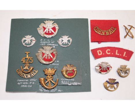 A selection of DCLI military badges and insignia including brass Field Service cap badge 1896-1900, Pioneer's collar badge, a