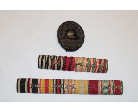 A First War German black grade wound badge and two Imperial German strips of medal ribbons with emblems