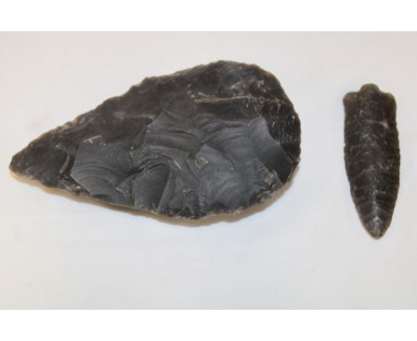 An ancient flint axe head, 5" long and one other similar flint arrow head (believed both excavated in the Gloucester area)